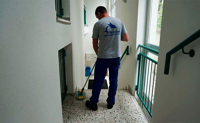 Fachkraft für Hausreinigung an der Arbeit in einem Treppenflur in Wien und Niederösterreich